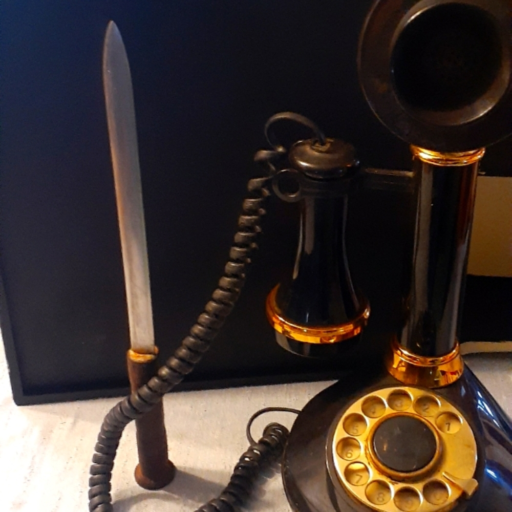 Vintage 1973 candlestick phone and 1970 letter opener .
